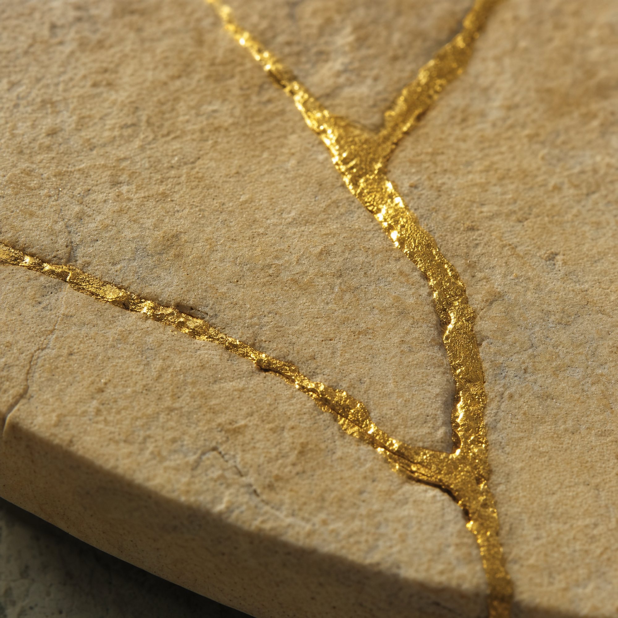 A crack in warm stone filled with gold